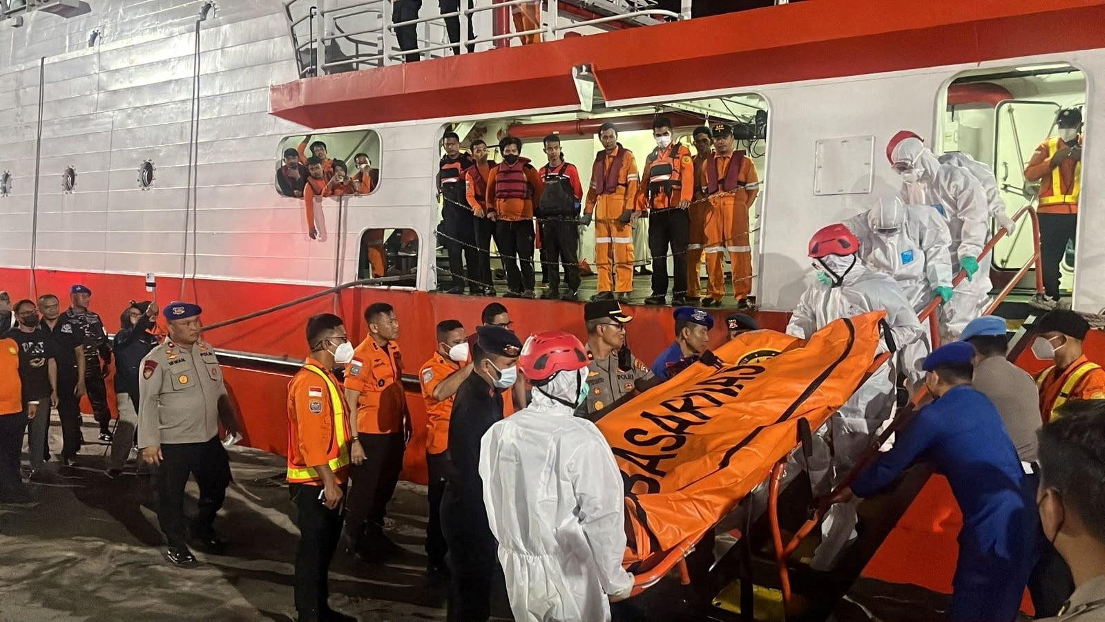Rescue members wearing personal protective equipment carry a body bag as they retrieve victims of the Virgo Transport 8 ferry, which capsized in the Java Sea while sailing from Surabaya to Banjarmasin, upon arrival at Trisakti Port in Banjarmasin, So