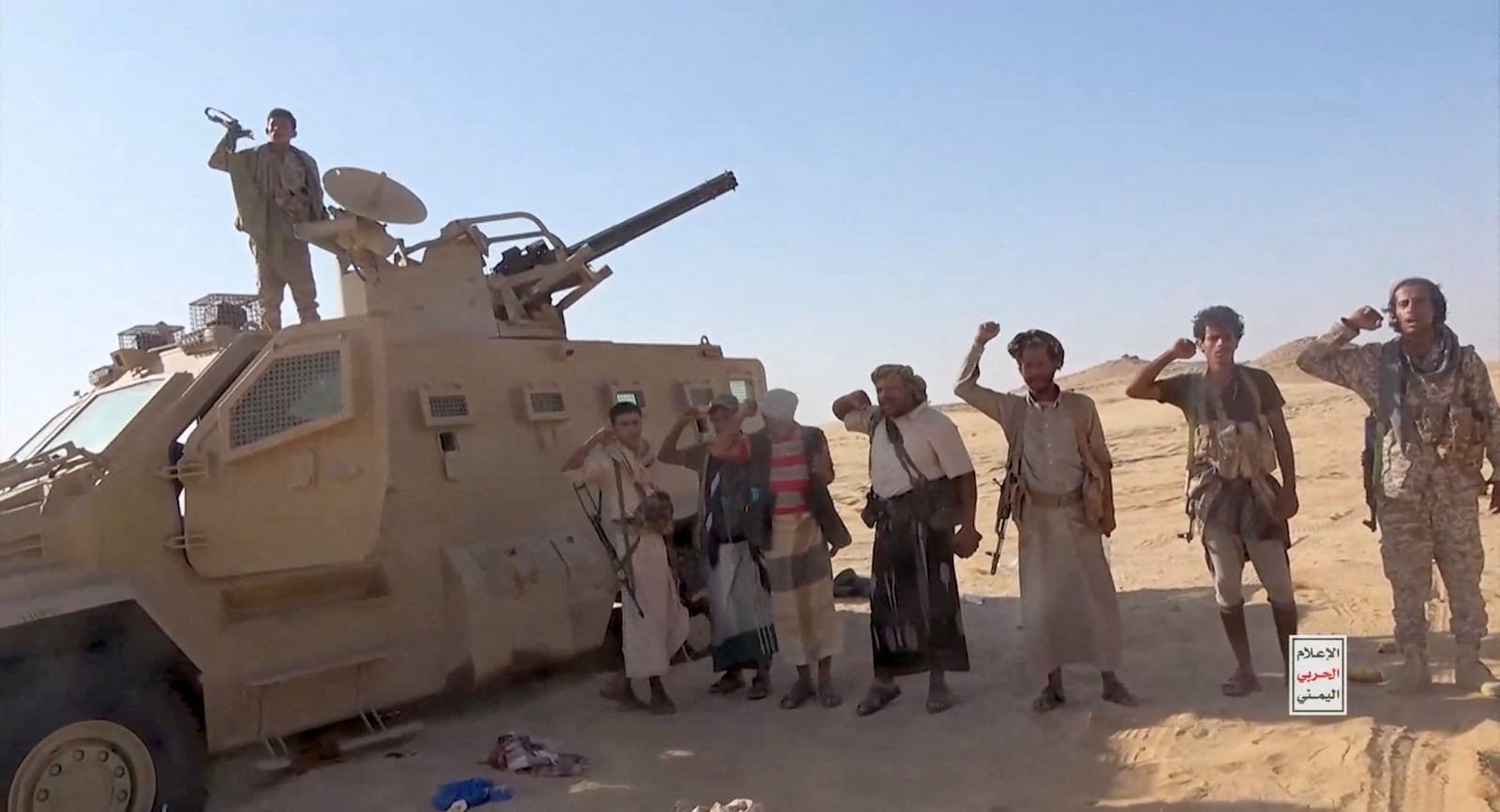 Iran-aligned Houthi fighters pose next to a captured vehicle following what the source described as an attack on Saudi-backed forces in the location given by the source as al Jawf governorate, Yemen, in this screengrab taken from a video released by