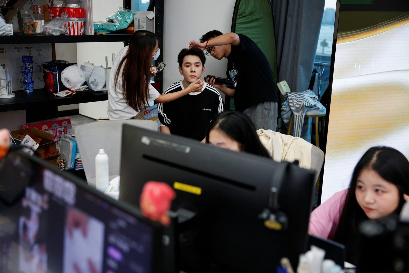 Li Jiaqi, a prominent livestreamer known for selling beauty and cosmetic products, has his makeup done by assistants at a livestream studio before a broadcast at the headquarters of MeiONE in Shanghai, China, September 7, 2026. REUTERS/Go Nakamura