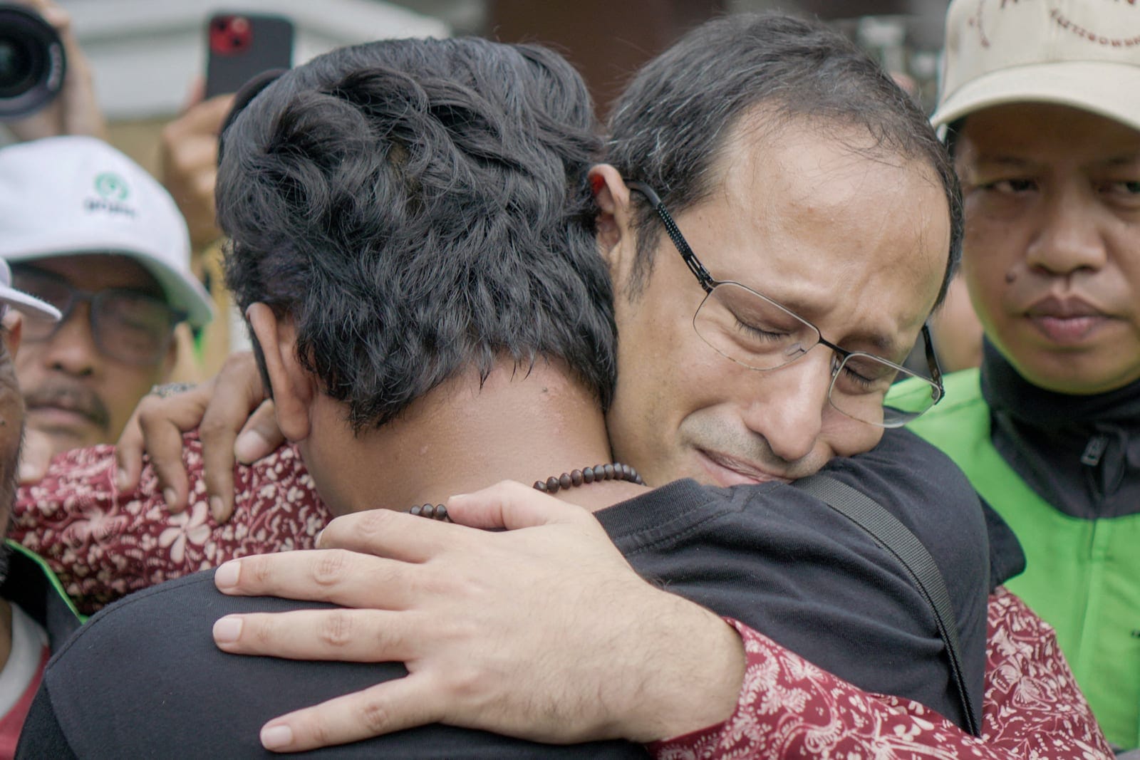 Nadiem Makarim, Indonesia's former education minister and co-founder of ride-hailing firm Gojek, hugs his supporter, after an appeal hearing for a graft conviction relating to improper laptop procurement, at the Central Jakarta Court in Jakarta, Indo