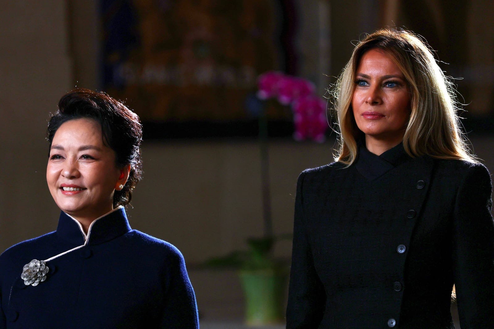 First lady of China Peng Liyuan and U.S. first lady Melania Trump listen as choir students from the Hope Chinese School perform during a visit to the Smithsonian's National Museum Of Asian Art from Director of the museum Chase Robinson in Washington,