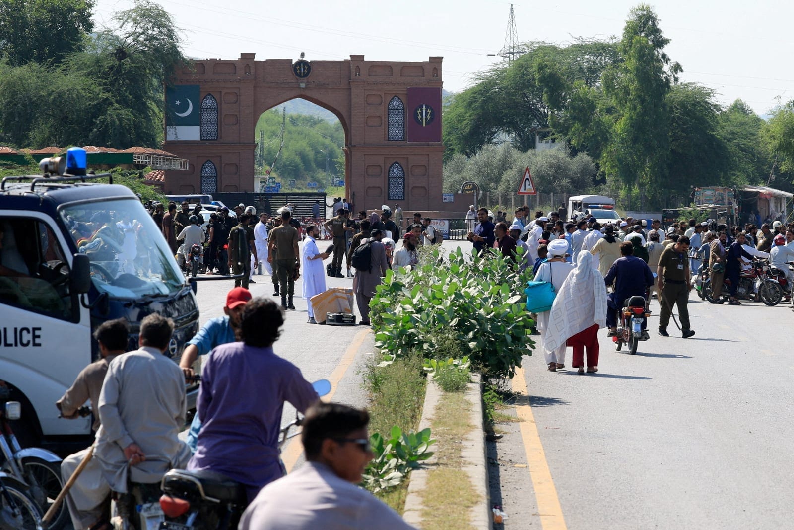 People gather as police closed the Grand Trunk Road ahead of a planned march by former Pakistani Prime Minister Imran Khan's party, PTI, from Peshawar to Islamabad, Pakistan, September 25, 2026. REUTERS/Staff
