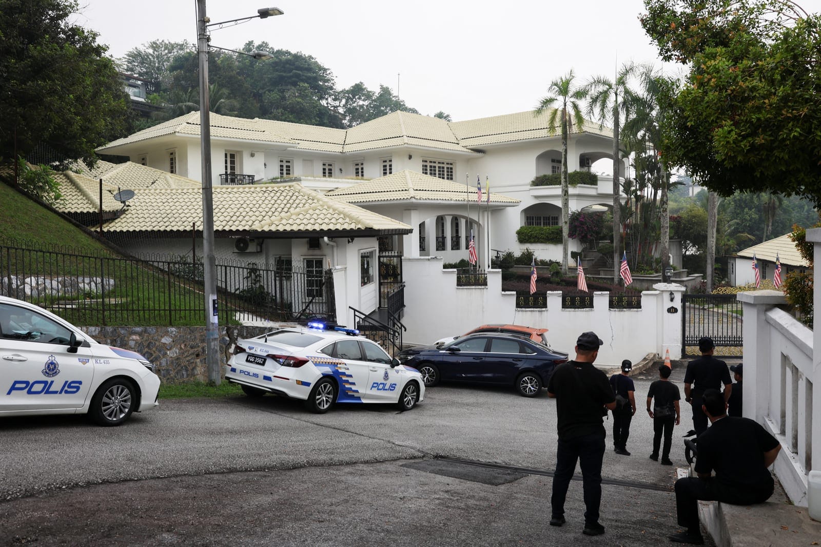 Police patrol cars are parked outside Malaysia’s former Prime Minister Najib Razak’s house after Malaysia’s King agreed to allow the jailed former premier to serve the remainder of his sentence under house arrest, in Kuala Lumpur, Malaysia, September