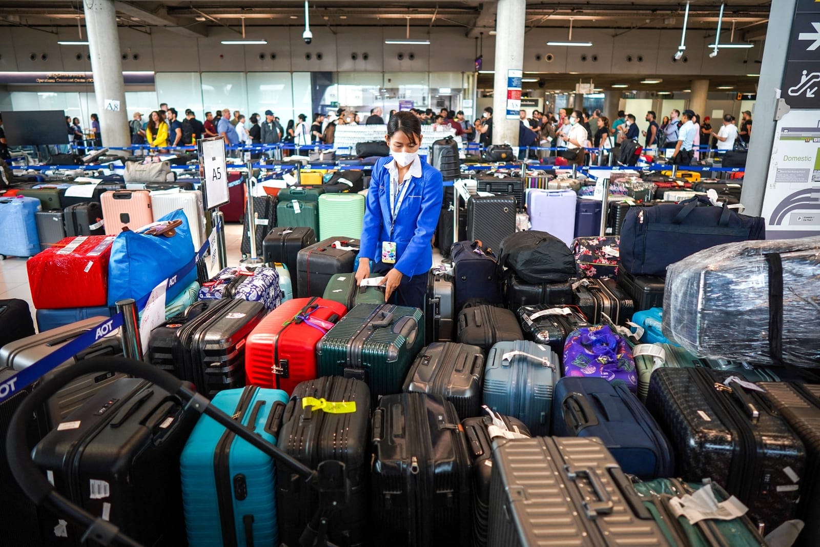 An airport officer arranges baggage from Thai Airways flights at Suvarnabhumi International Airport, after heavy rain and flooding disrupted the airline's ground operations, in Bangkok, Thailand, September 29, 2026. REUTERS/Athit Perawongmetha