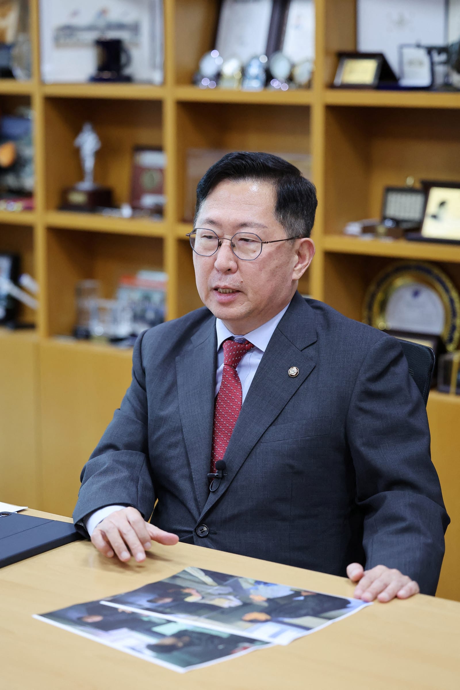 Lawmaker Yu Yong-weon of South Korea’s main opposition People Power Party explains pictures, showing two North Korean POWs who were recently transferred from Ukraine to South Korea, taken during his visit to a POW camp in Ukraine last February, at hi
