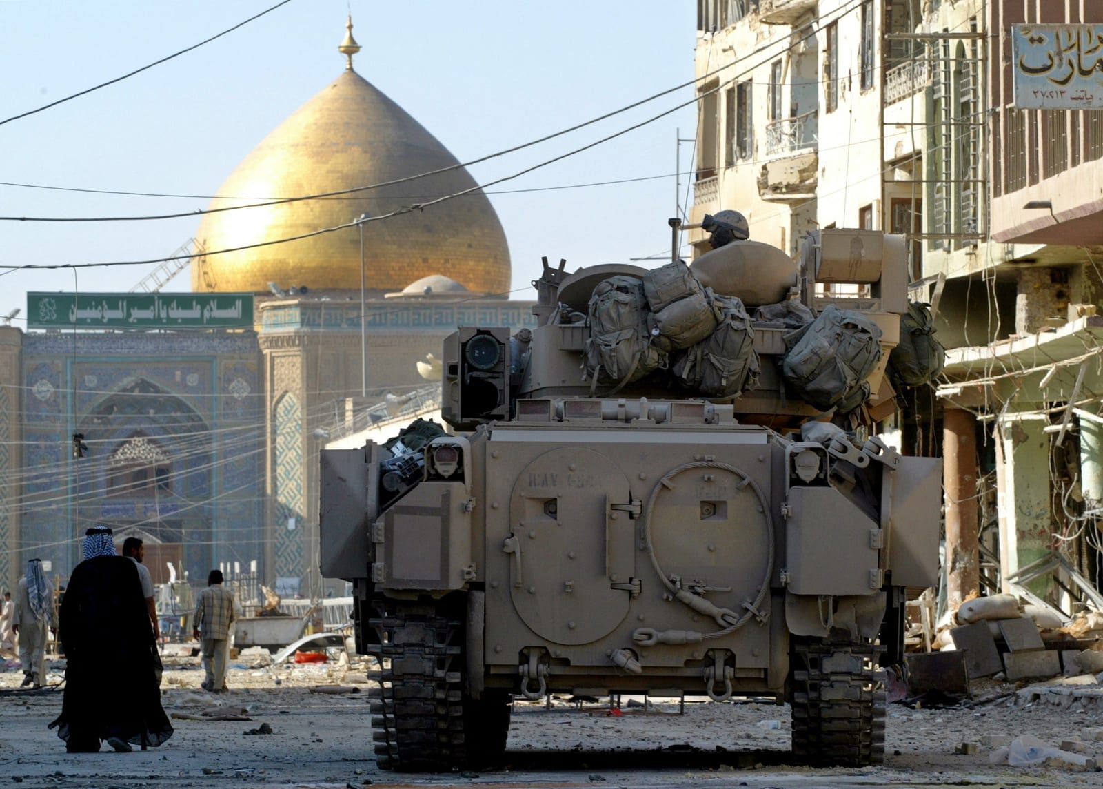 A U.S. Army Bradley armoured vehicle of the 1st Cavalry division guards a street leading from the cemetery to Imam Ali shrine, in Najaf, Iraq, August 27, 2004. REUTERS/Chris Helgren/File Photo