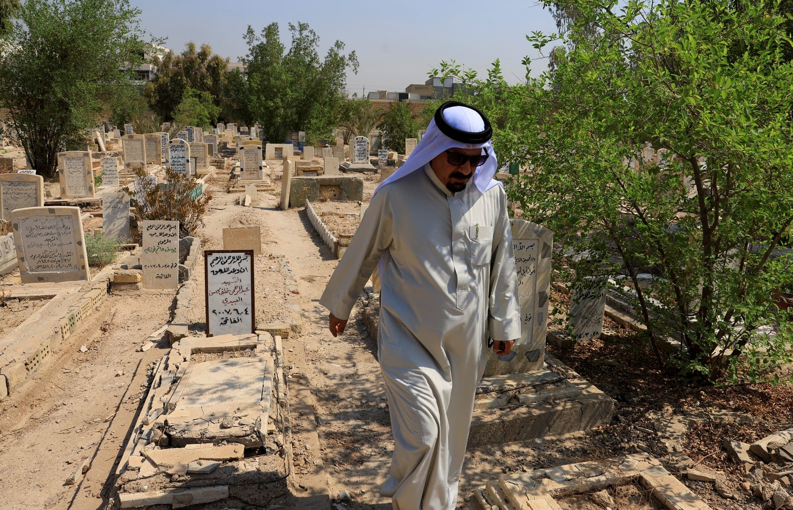 Sunni tribal sheikh Abdul Rahman al-Zobaie walks through the Martyrs' Cemetery in Falluja, Iraq September 27, 2026. More than two decades after the western Iraqi city of Falluja became a major centre of resistance to US-led forces in Iraq, residents