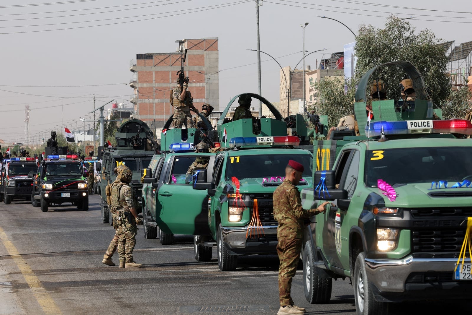 Members of the Iraqi security forces take part in a convoy moving through the city as they celebrate the withdrawal of US-led coalition forces from Iraq, ending a military presence that began after the 2003 US-led invasion, in Najaf, Iraq, September