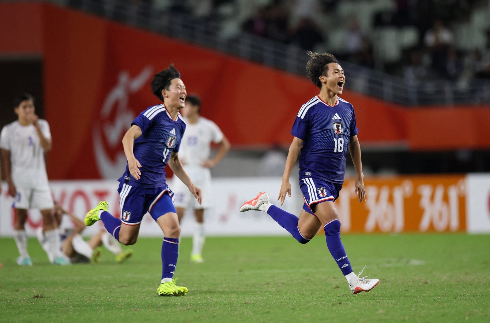Asian Games - Aichi-Nagoya 2026 - Football Men Semi-Finals - Japan v Uzbekistan - Nagai Stadium, Osaka, Japan - September 30, 2026 Japan's Yudai Shimamoto and Kaito Tsuchiya celebrate after the match REUTERS/Andrew Boyers
