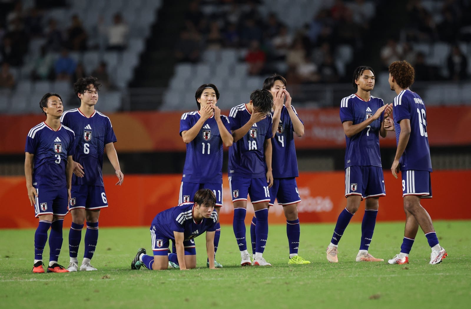 Asian Games - Aichi-Nagoya 2026 - Football Men Semi-Finals - Japan v Uzbekistan - Nagai Stadium, Osaka, Japan - September 30, 2026 Japan players react during the penalty shootout REUTERS/Andrew Boyers