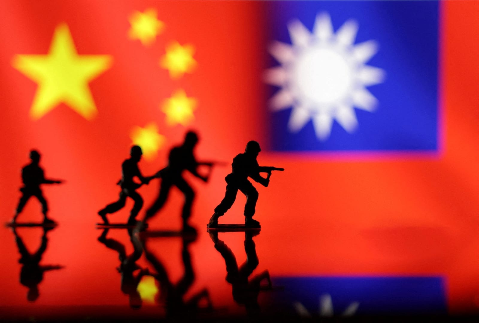 FILE PHOTO: Solider miniatures are seen in front of displayed Chinese and Taiwanese flags in this illustration taken, April 11, 2023. REUTERS/Dado Ruvic/Illustration/File Photo