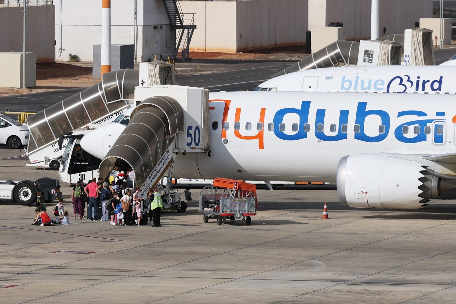 Travelers board a FlyDubai aircraft at Ben Gurion International Airport after a separate FlyDubai flight from the United Arab Emirates to Israel was diverted to Saudi Arabia following an emergency signal, in Lod, near Tel Aviv, Israel, September 30, 
