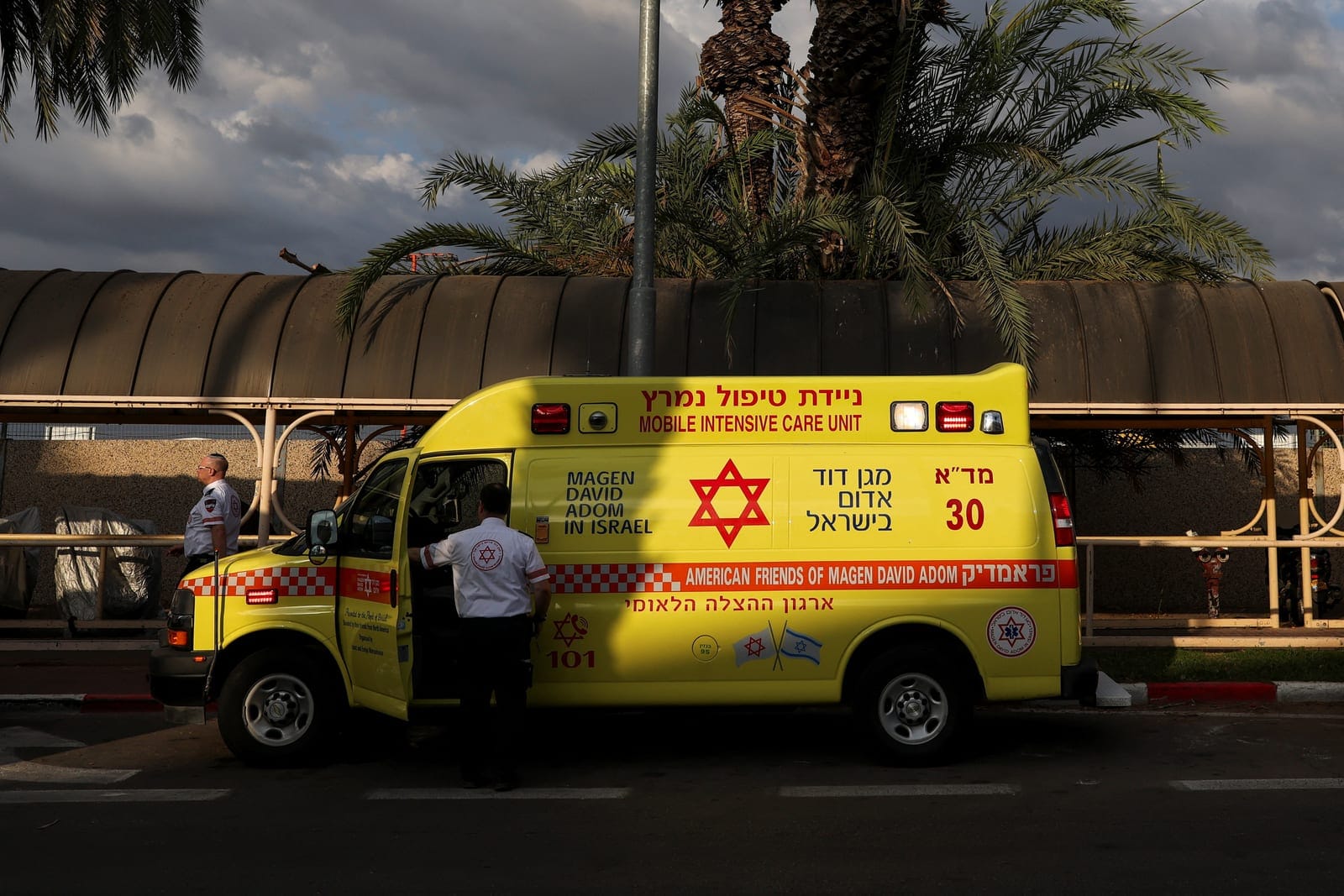 Ambulances wait at the Ben Gurion International Airport for the arrival of passengers from a FlyDubai aircraft bound for Israel from the United Arab Emirates, which was diverted to Saudi Arabia following an emergency signal, in Lod, near Tel Aviv, Is