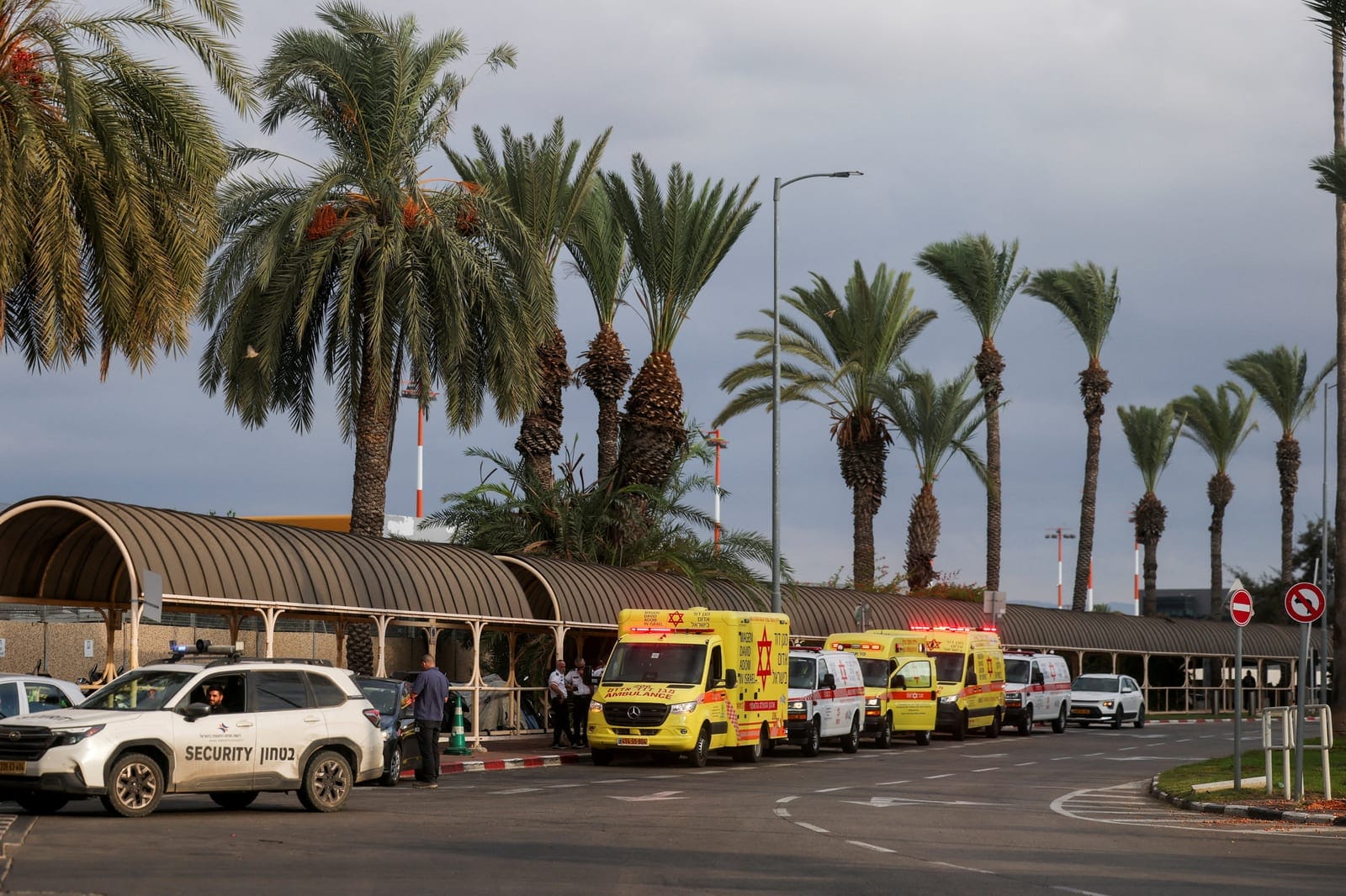 Ambulances wait at the Ben Gurion International Airport for the arrival of passengers from a FlyDubai aircraft bound for Israel from the United Arab Emirates, which was diverted to Saudi Arabia following an emergency signal, in Lod, near Tel Aviv, Is