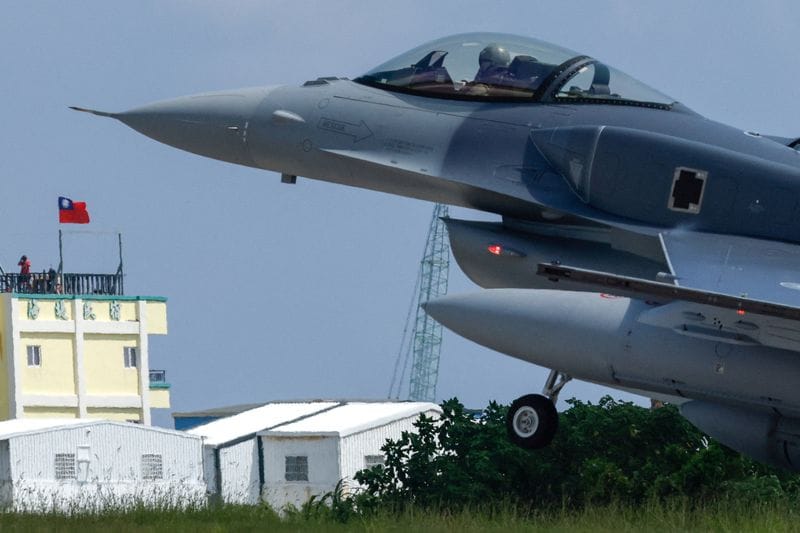 A Lockheed Martin F-16V fighter jet lands at Taitung's Chihhang Air Base in Taitung as people watch from a nearby hotel in Taitung