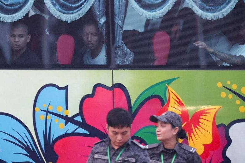 Myanmar nationals due to be repatriated from Malaysia sit inside a bus at Lumut
