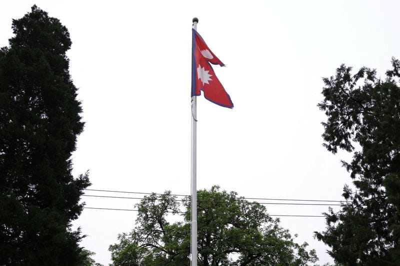 National flag of Nepal flutters at the Embassy of Nepal, in Beijing