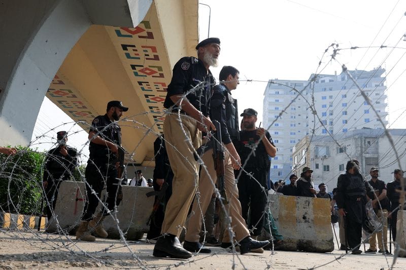 Police guard a road leading to Red Zone, in Peshawar