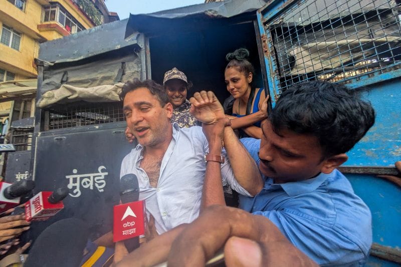 Bollywood actor Imran Khan is detained by security personnel during a protest by the Cockroach Janta Party (CJP) seeking the resignation of India's Chief Election Commissioner Gyanesh Kumar,
