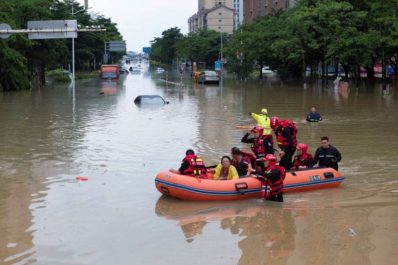 Rescue workers evacuating flood-affected residents by boat  in Putian