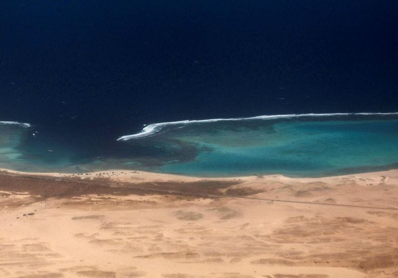 An aerial view shows the coast of the Red Sea, through the window of a plane before landing, in Marsa Alam