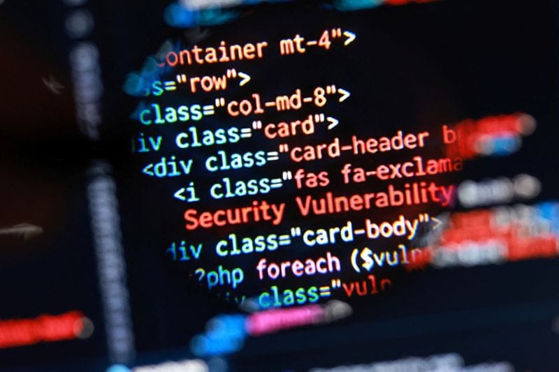 Illustration shows "Security Vulnerability" phrase and PHP code