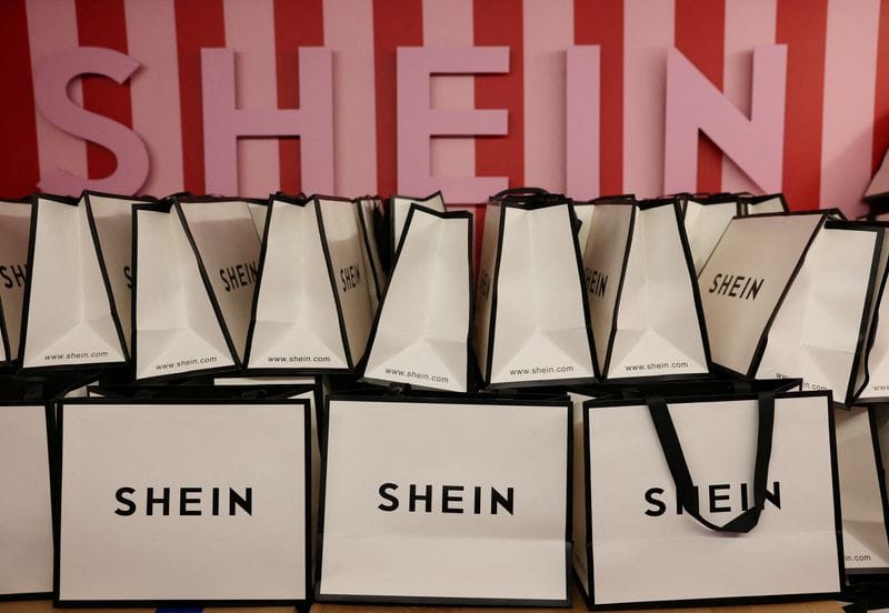 FILE PHOTO: A company logo for fashion brand Shein is seen on a pile of gift bags on its Christmas bus as part of a nationwide promotional tour in Liverpool, Britain