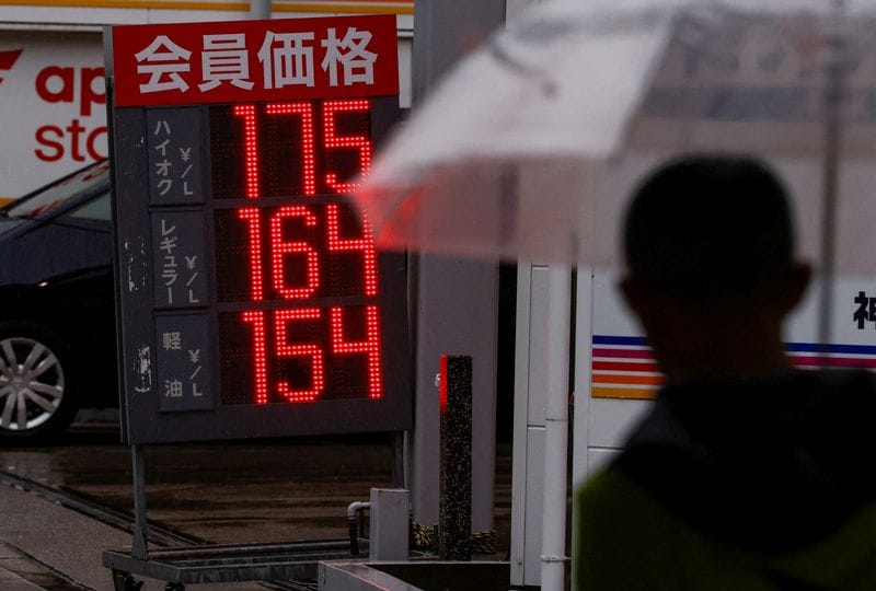 FILE PHOTO: Signboards display fuel prices outside gas stations in Tokyo