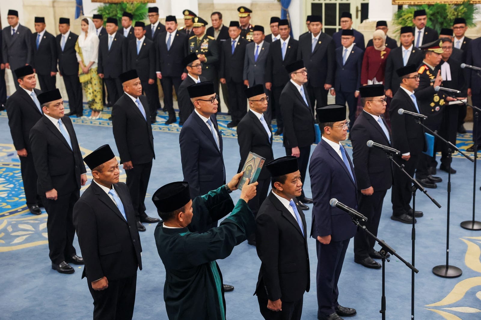 Indonesia's newly appointed Coordinating Minister for Downstreaming and Energy Transition Bahlil Lahadalia, Coordinating Minister for Human Development and Cultural Affairs Sugiono, Foreign Minister Arrmanatha Nasir and other government officials tak