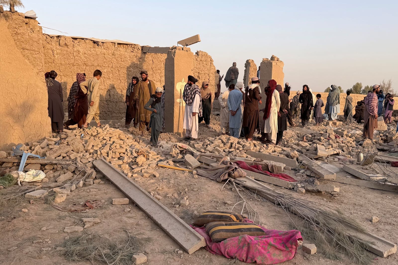 People stand on the rubble of a house that was damaged in what the Taliban said was a Pakistani airstrike in Garmsir district in Helmand province, Afghanistan, October 1, 2026. Picture taken with a mobile phone. REUTERS/Stringer