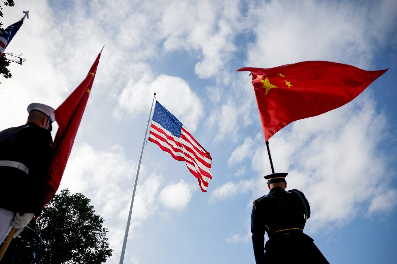 A U.S. flag flutters as members of the honour guard carry Chinese flags on the South Lawn of the White House in Washington, D.C., US, September 24, 2026. REUTERS/Evan Vucci