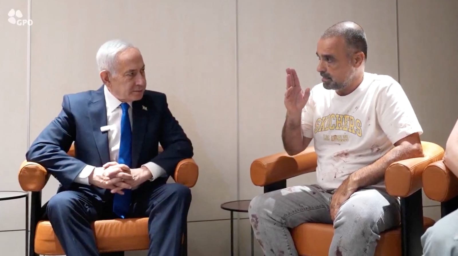 Israeli Prime Minister Benjamin Netanyahu meets Yaniv Hayun, a passenger on the FlyDubai flight bound for Israel from the United Arab Emirates, which was diverted to Saudi Arabia following an emergency signal, at the Ben Gurion Airport, Israel, Octob