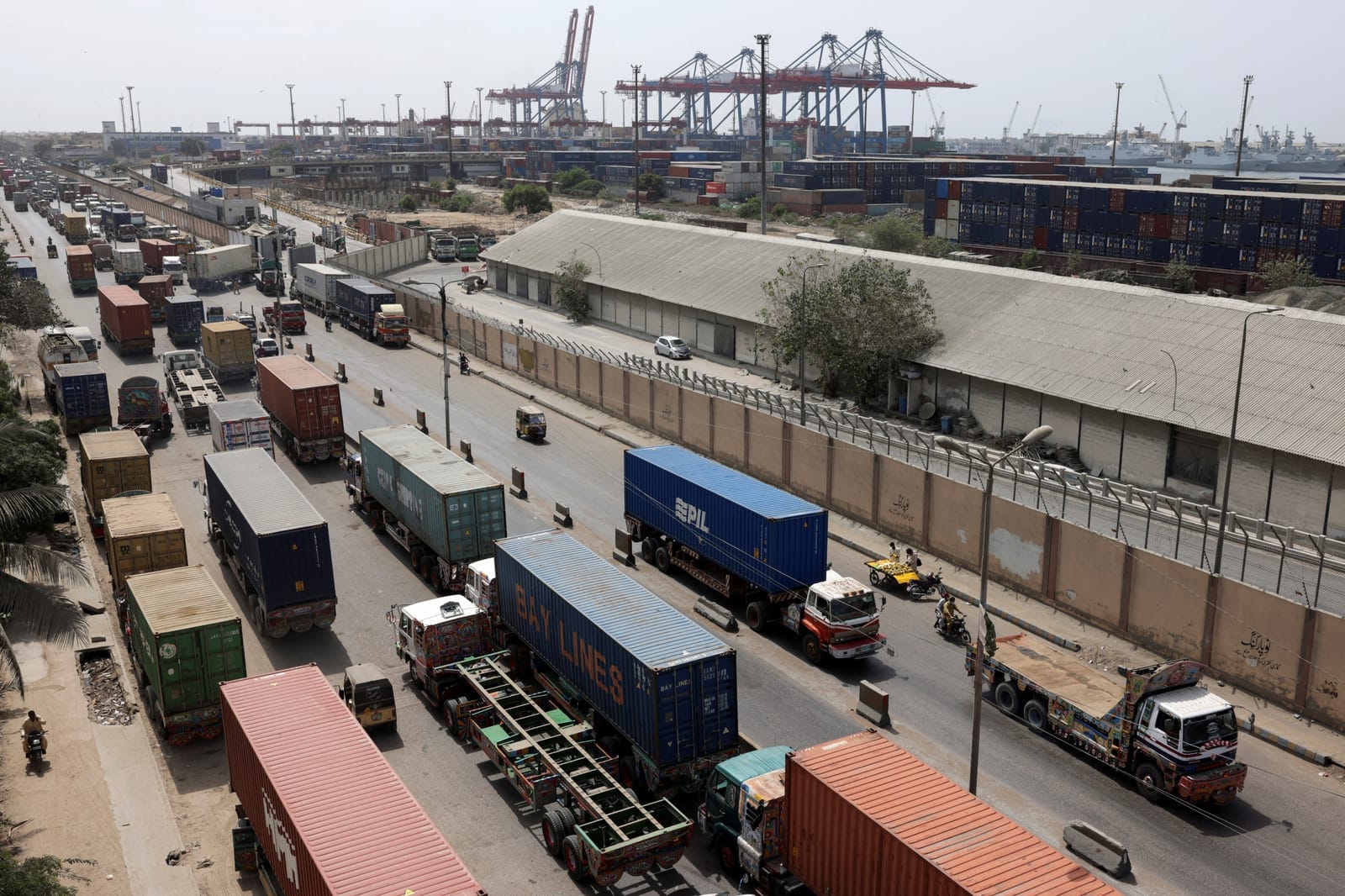 Trailers loaded with shipping containers are parked near the port area in Karachi, Pakistan, September 30, 2026. REUTERS/Stringer