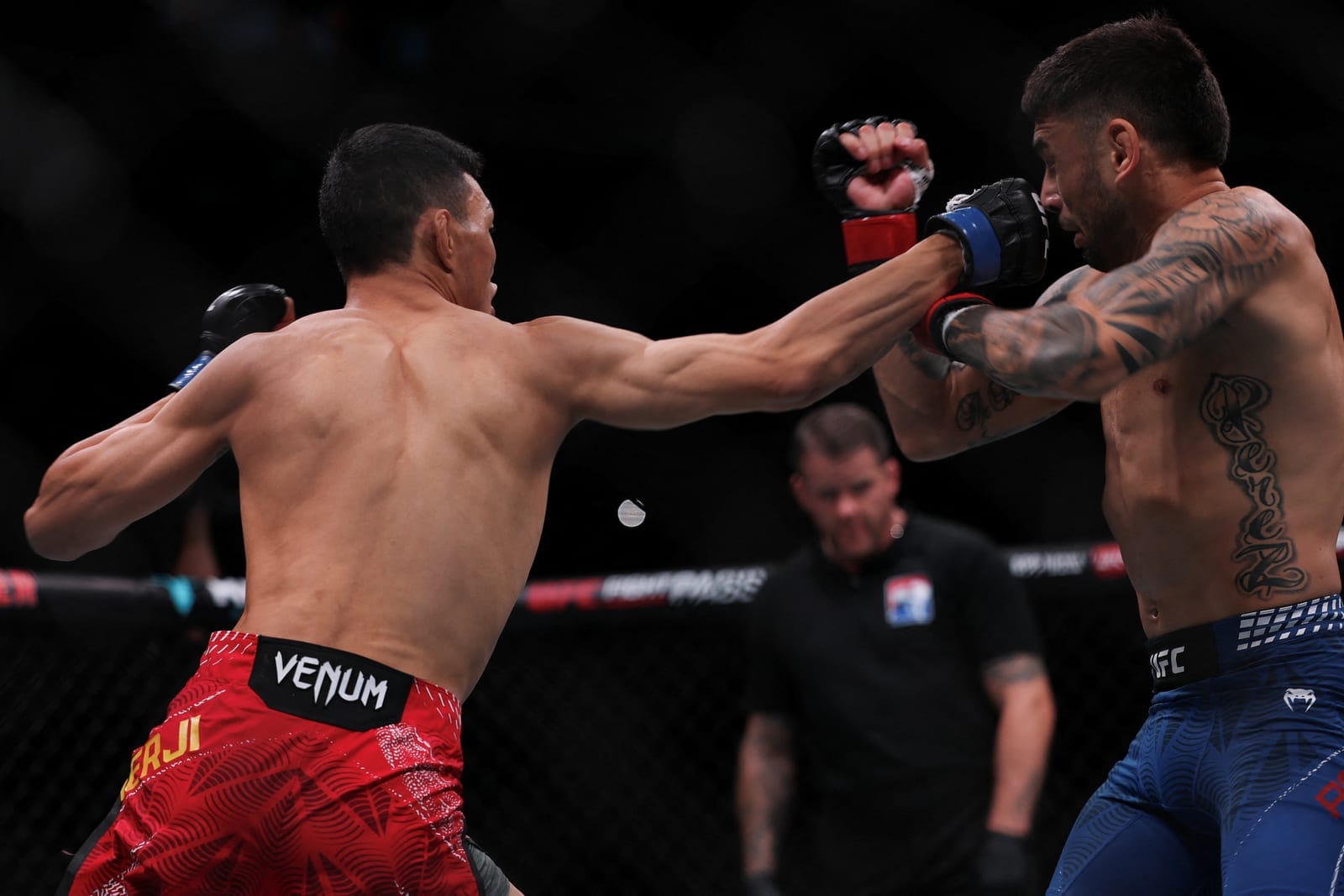 UFC flyweight fighter Su Mudaerji, and Alex Perez compete in the Octagon during a UFC event in Shanghai, China, August 29, 2026. REUTERS/Go Nakamura