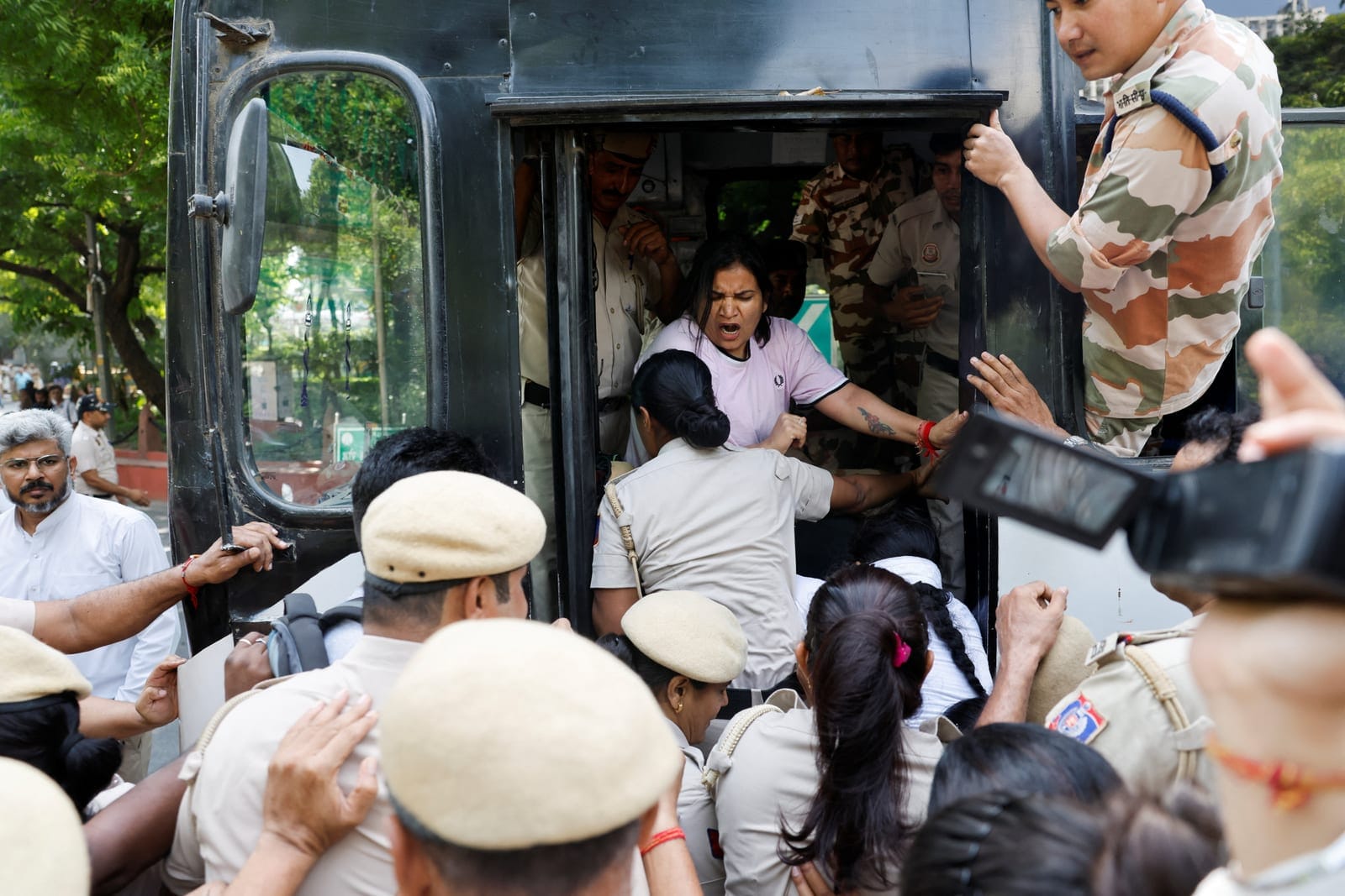 Police officers detain protesters during a protest demanding the resignation of India's Chief Election Commissioner Gyanesh Kumar, in New Delhi, India, October 2, 2026. REUTERS/Adnan Abidi