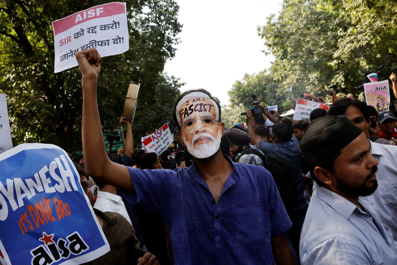 A demonstrator wears a mask depicting Indian Prime Minister Narendra Modi during a protest demanding the resignation of India's Chief Election Commissioner Gyanesh Kumar, in New Delhi, India, October 3, 2026. REUTERS/Adnan Abidi