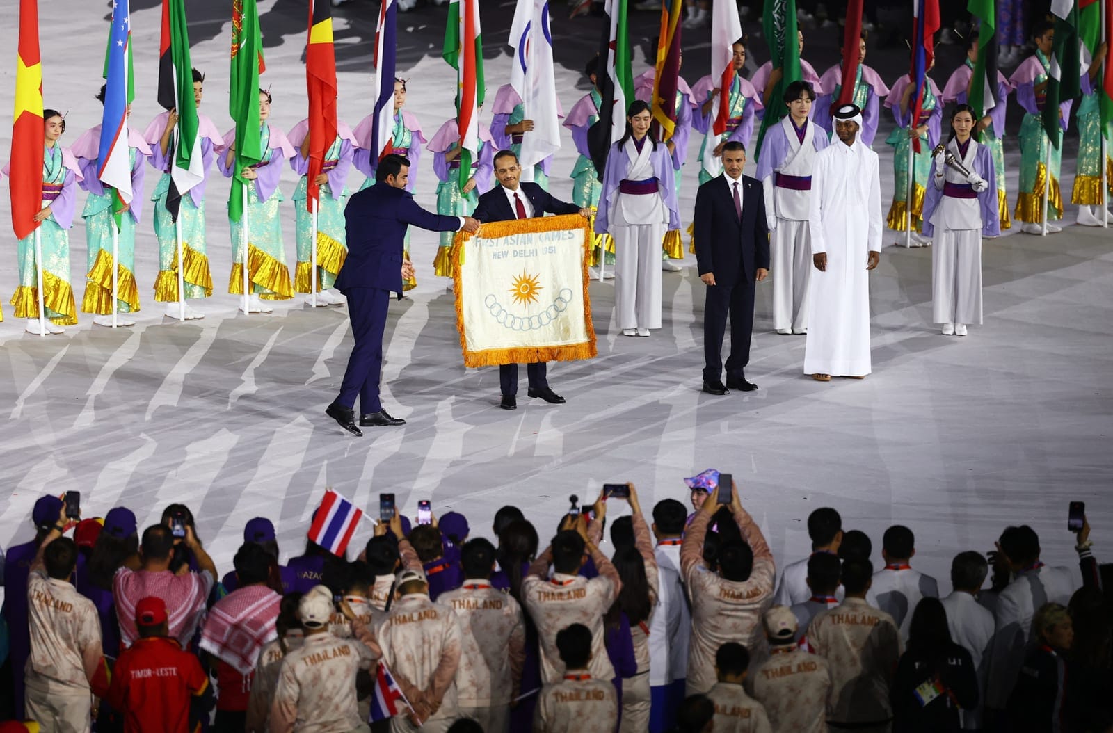 Asian Games - Aichi-Nagoya 2026 - Closing Ceremony - Paloma Mizuho Stadium, Nagoya, Japan - October 4, 2026 OCA president Sheikh Joaan bin Hamad Al Thani passes on the flag of the first Asian Games to Qatar's Prime Minister Sheikh Mohammed bin Abdulr