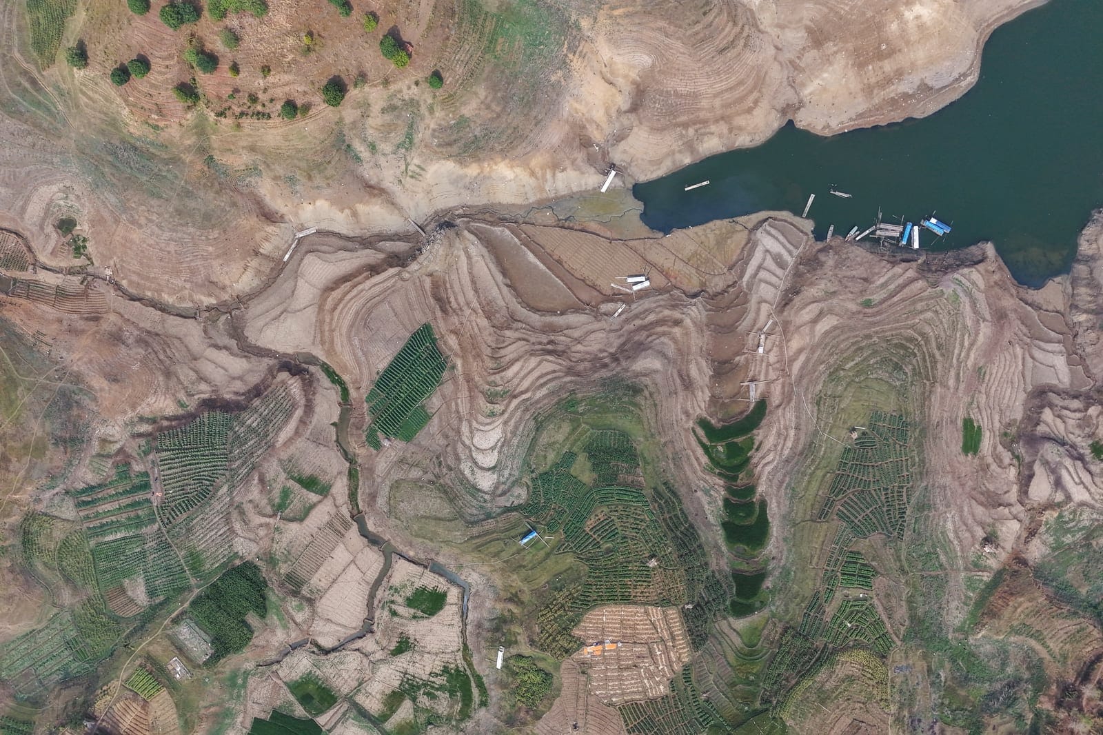 A drone view shows areas exposed from Jatigede Reservoir as water levels recede amid drought during the dry season in Sumedang Regency, West Java province, Indonesia, October 1, 2026. REUTERS/Claudio Pramana