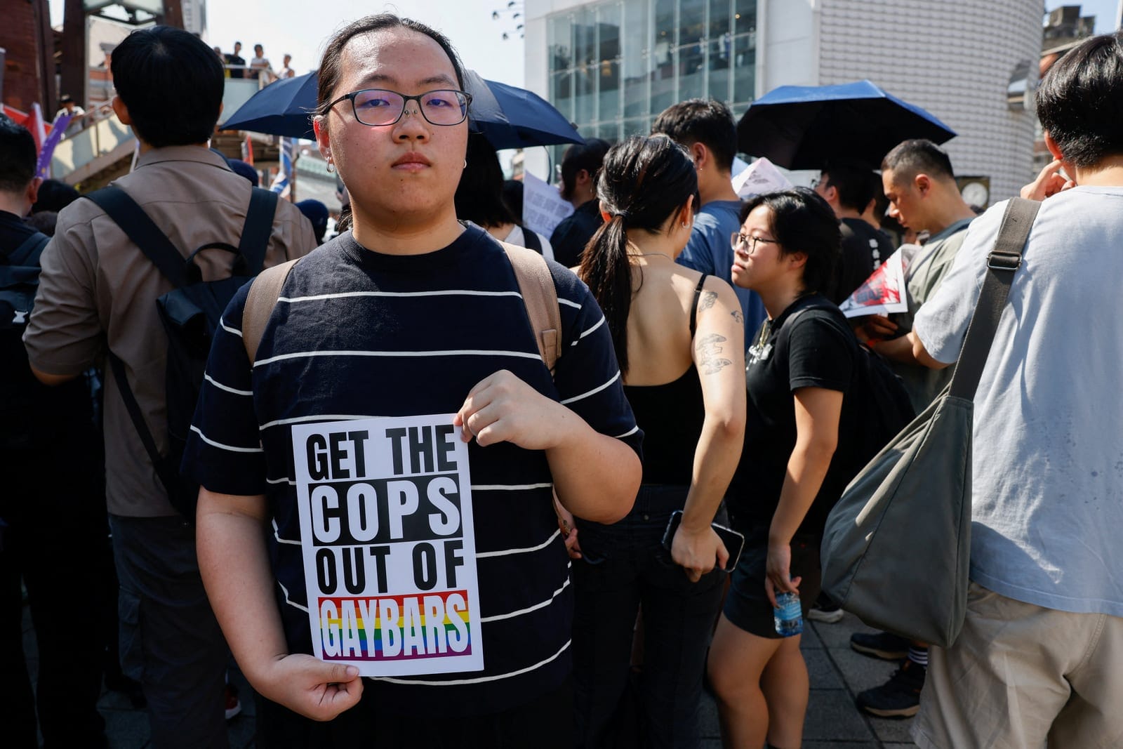 A protestor holds a sign as people march and protest after police raided a gay bar ahead of the annual Taiwan Pride parade, in Taipei, Taiwan, October 4, 2026. REUTERS/Ann Wang