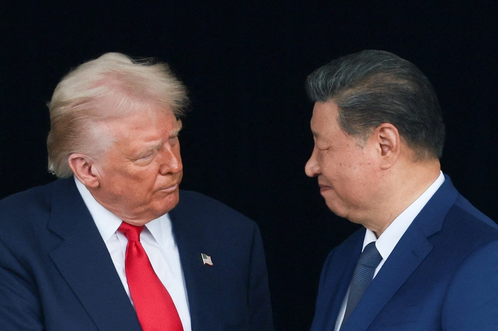 U.S. President Donald Trump and Chinese President Xi Jinping talk as they leave after a bilateral meeting at Gimhae International Airport, on the sidelines of the Asia-Pacific Economic Cooperation (APEC) summit, in Busan, South Korea, October 30, 202