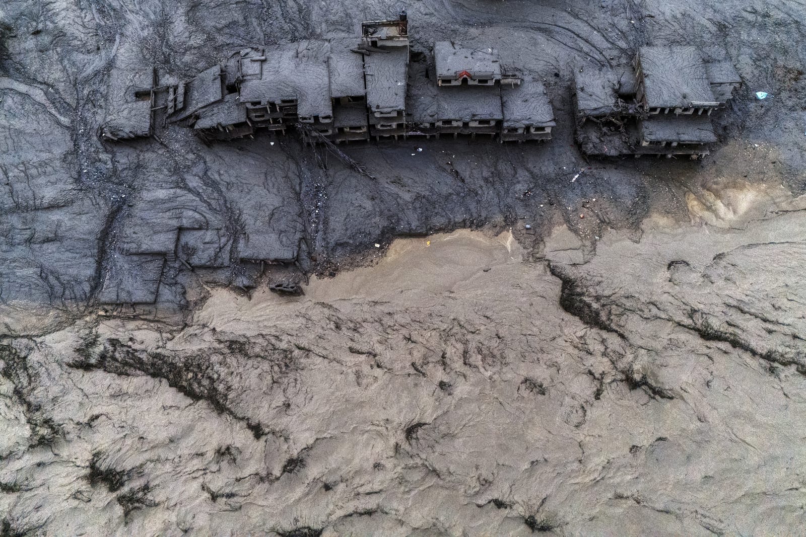FILE PHOTO: A drone view shows damaged buildings covered in mud next to the Likhu River following deadly flash floods and mudslides in Devighat, Nuwakot district, Nepal, August 30, 2026. REUTERS/Athit Perawongmetha/File Photo