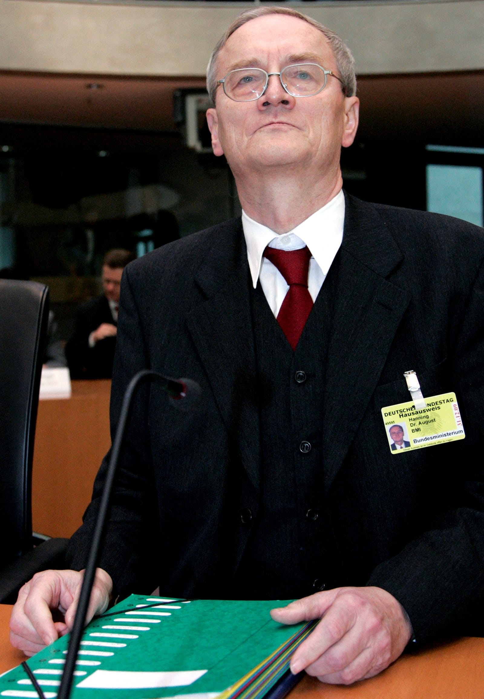 FILE PHOTO: August Hanning, state secretary at the German Interior Ministry and former head of Germany's Federal Intelligence Service (BND), holds his files before the start of a parliamentary committee of investigation in Berlin, Germany, November 3