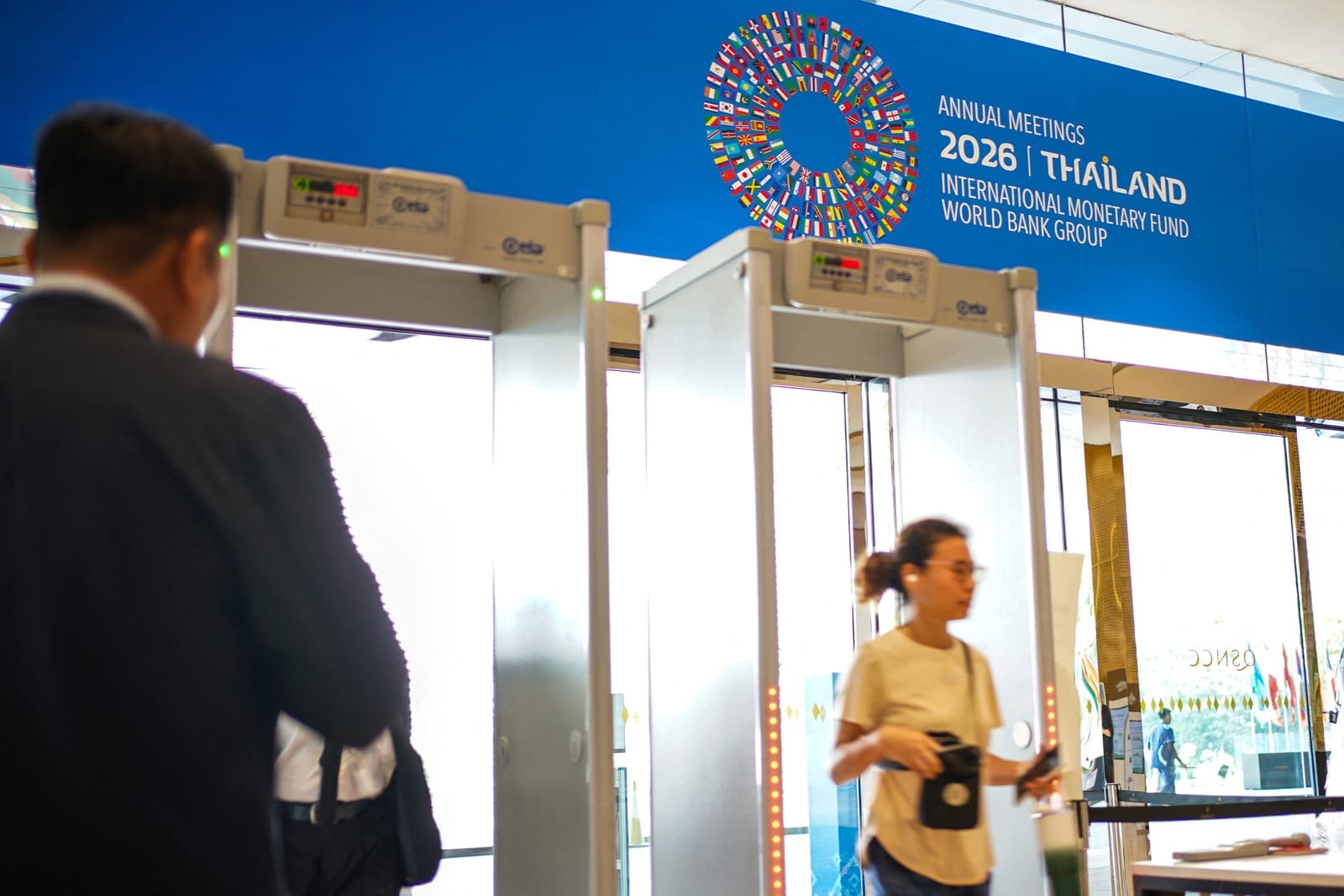 A woman walks past a security gate under the 2026 IMF-World Bank Annual Meetings, ahead of the meeting at Queen Sirikit National Convention Center (QSNCC) in Bangkok, Thailand, October 9, 2026. REUTERS/Athit Perawongmetha