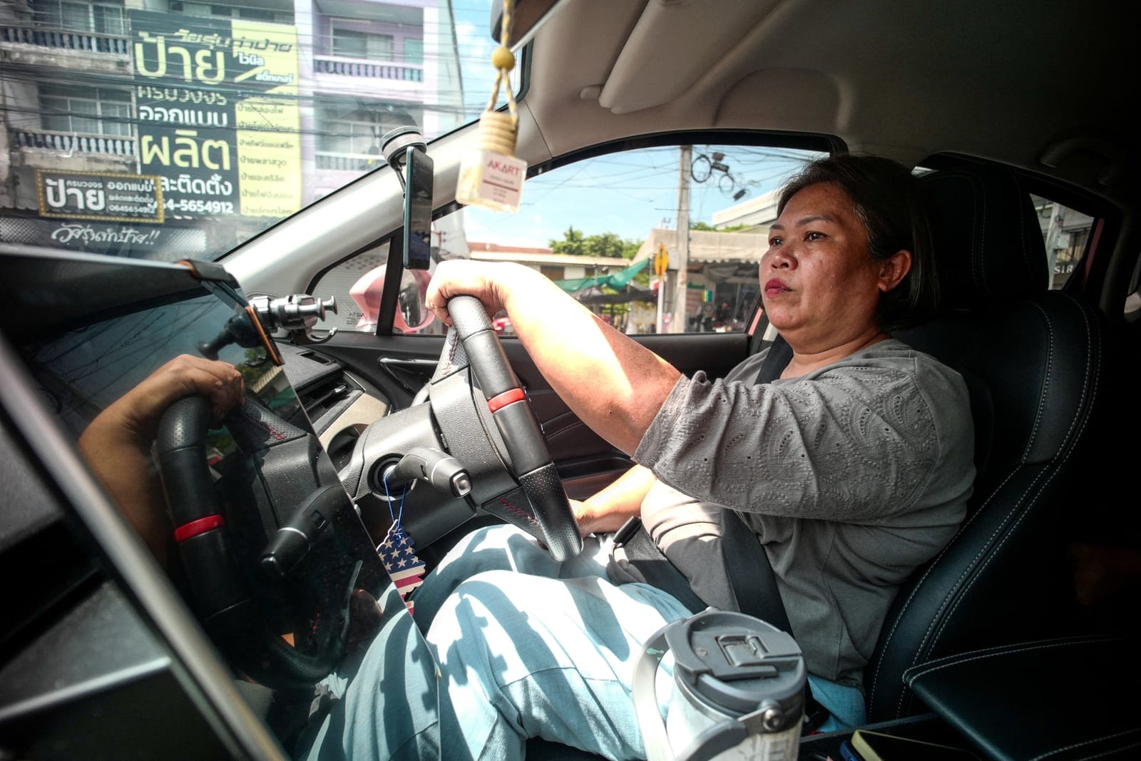 Kavita Wongyakasem, 51, a small-business owner who says she has about 10 million baht in debt, drives a Grab car to earn additional income to help repay her debt, in Nonthaburi province on the outskirts of Bangkok, Thailand, September 23, 2026. REUTE