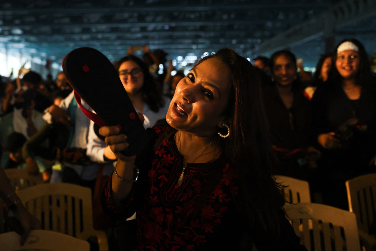 A woman supporter of the Cockroach Janta Party (CJP) holds up a flip-flop while protesting for women’s safety in Bengaluru, India, October 8, 2026. REUTERS/Priyanshu Singh