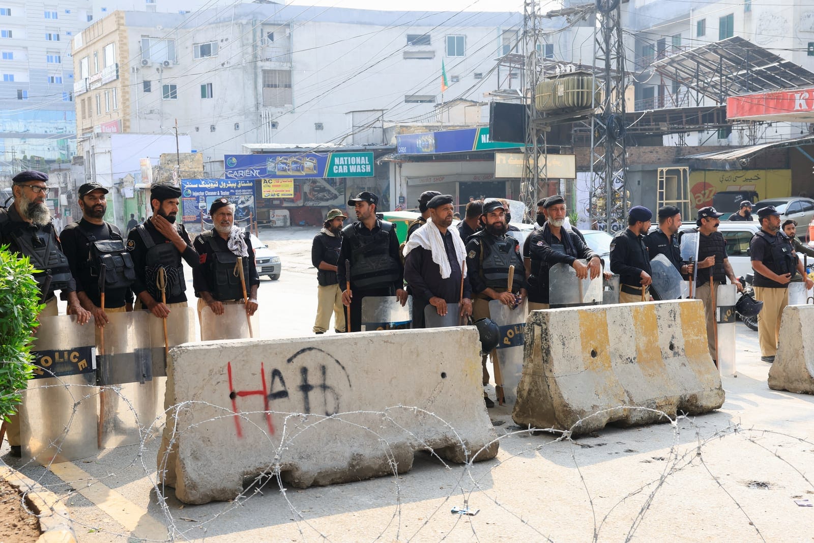 Members of the police guard a road leading to the Red Zone, in Peshawar, Khyber Pakhtunkhwa province, Pakistan, October 11, 2026. REUTERS REUTERS/Reuters