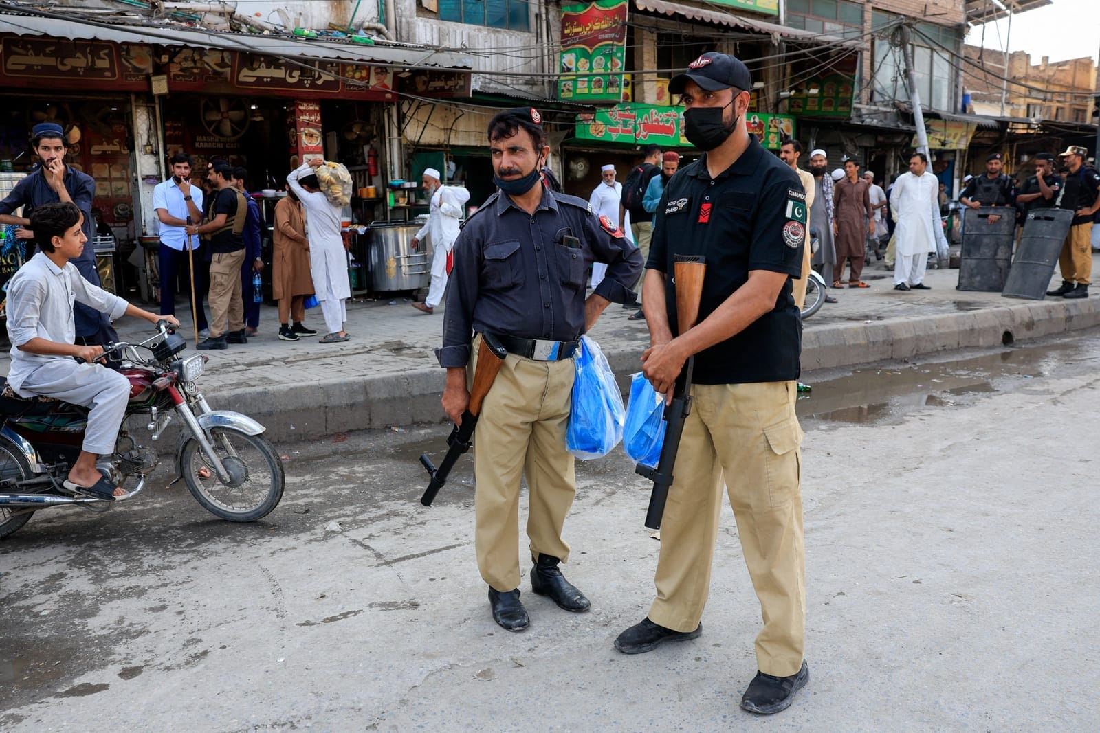 Police officers stand guard with tear gas launchers as a security measure following a protest call by supporters of jailed former Pakistani Prime Minister Imran Khan's party, Pakistan Tehreek-e-Insaf (PTI), a day after Pakistan imposed a state of eme