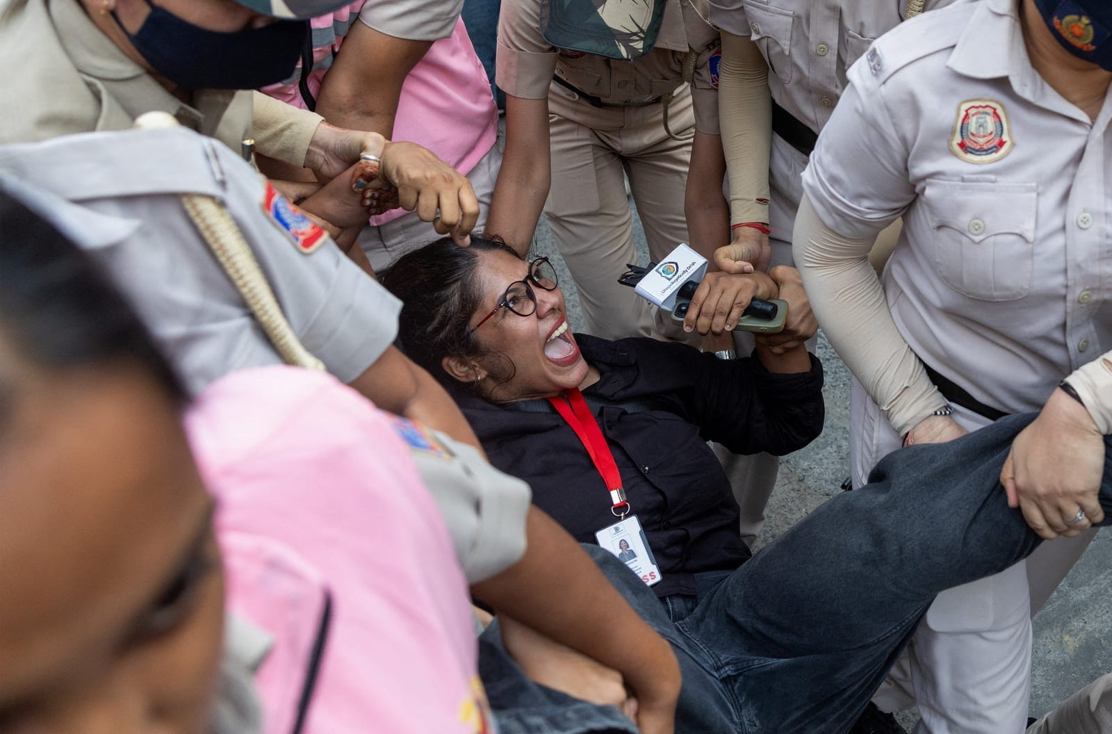 Security personnel detain a journalist during a protest by the Cockroach Janta Party (CJP) seeking the resignation of India's Chief Election Commissioner Gyanesh Kumar, near the protest site in New Delhi, India, October 11, 2026. REUTERS/Adnan Abidi