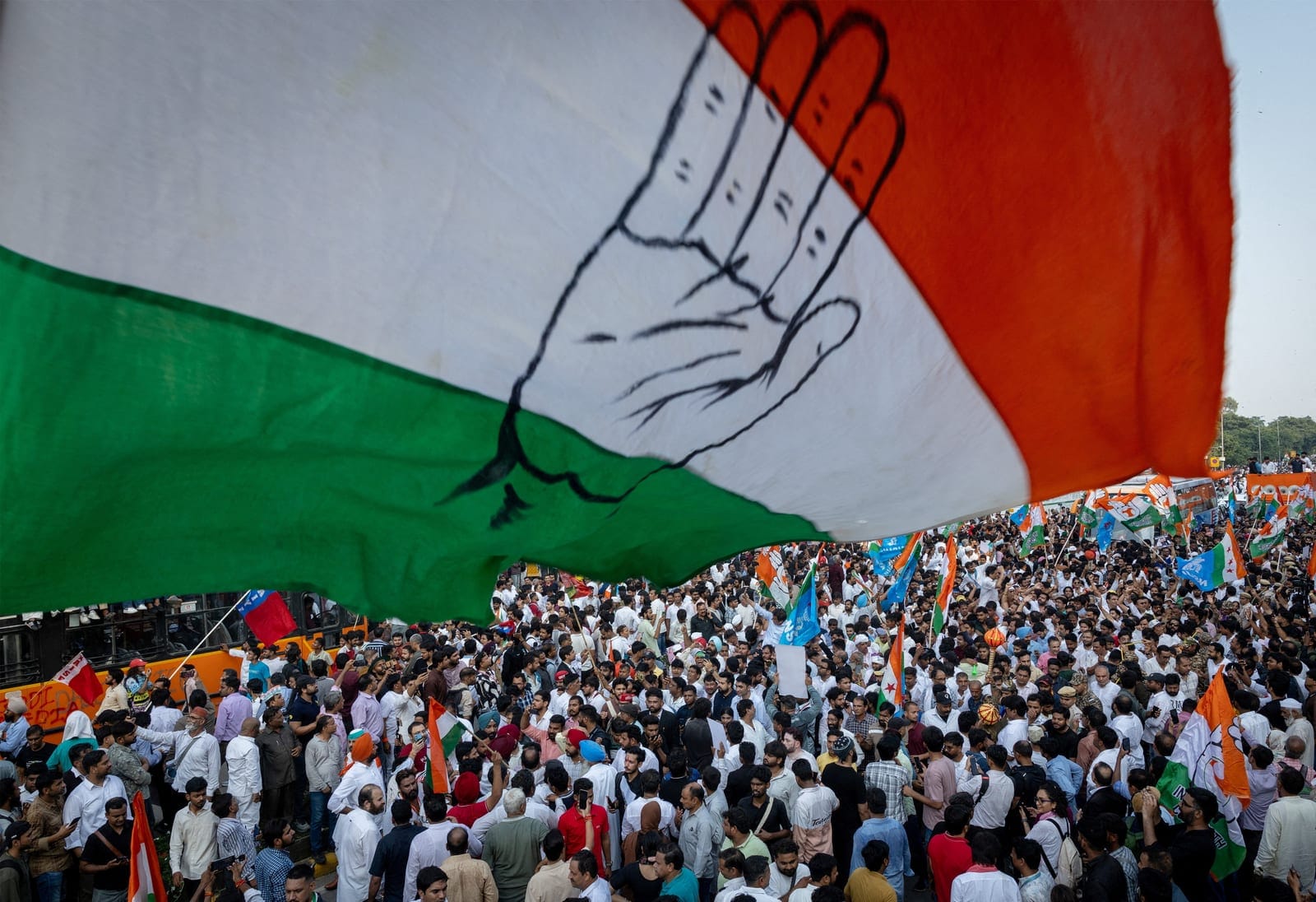 Supporters surround a bus carrying the leaders of India's opposition parties as they take part in a march to the Supreme Court in protest against a controversial revision of voter lists that has sparked days of unrest, in New Delhi, India, October 12