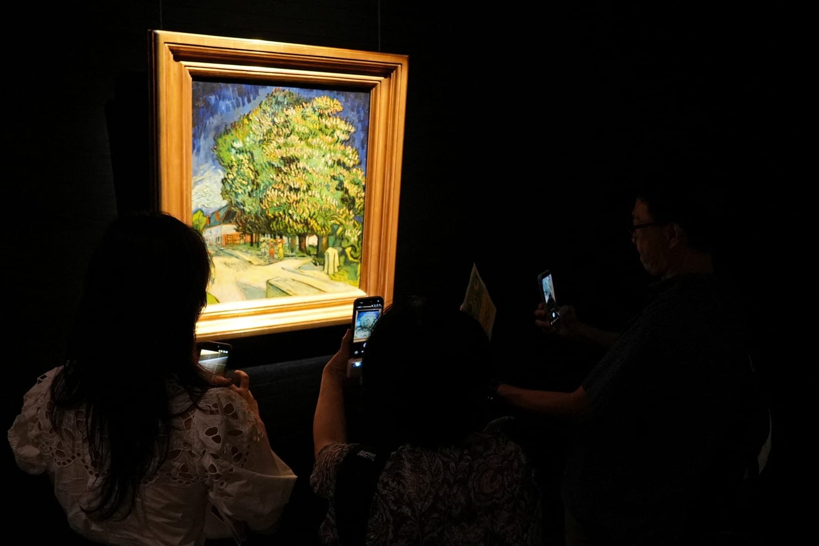Visitors look at Vincent van Gogh's "Chataigniers en fleurs" (Chestnut Trees in Blossom), on display ahead of its auction in New York, at Sotheby's in Hong Kong, China, October 13, 2026. REUTERS/Joyce Zhou